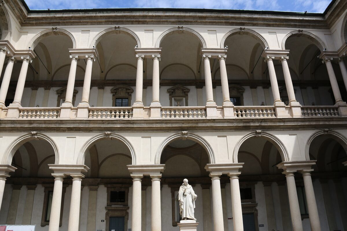 The arcaded courtyard of the Brera palace with a statue