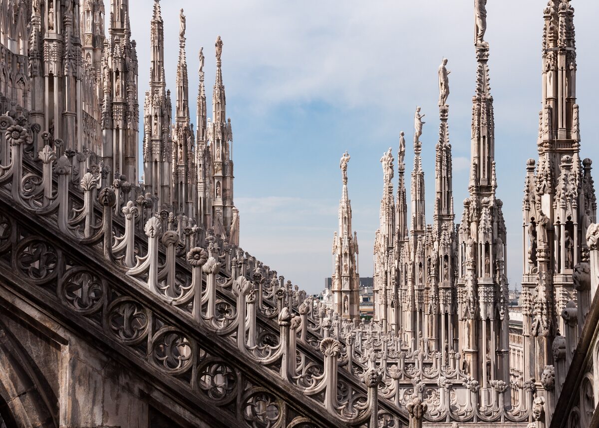 Marble spires and flying buttresses on the roof of Milan Cathedral