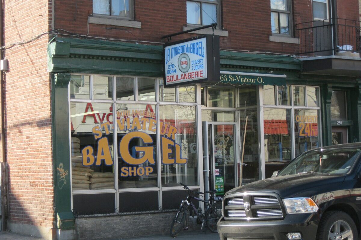 The corner shopfront of St-Viateur Bagel Shop on Rue Saint-Viateur in Mile End, with its yellow window lettering and a Boulangerie sign above the door