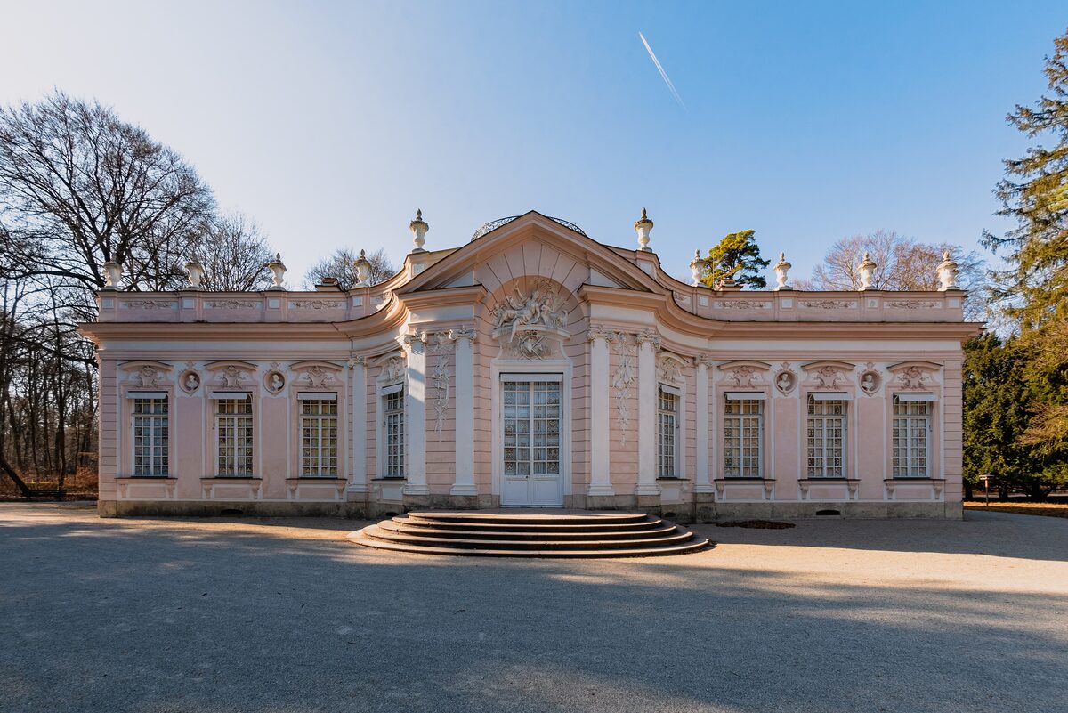 The pink and white rococo Amalienburg hunting lodge in Nymphenburg Park, with its curved front and low steps