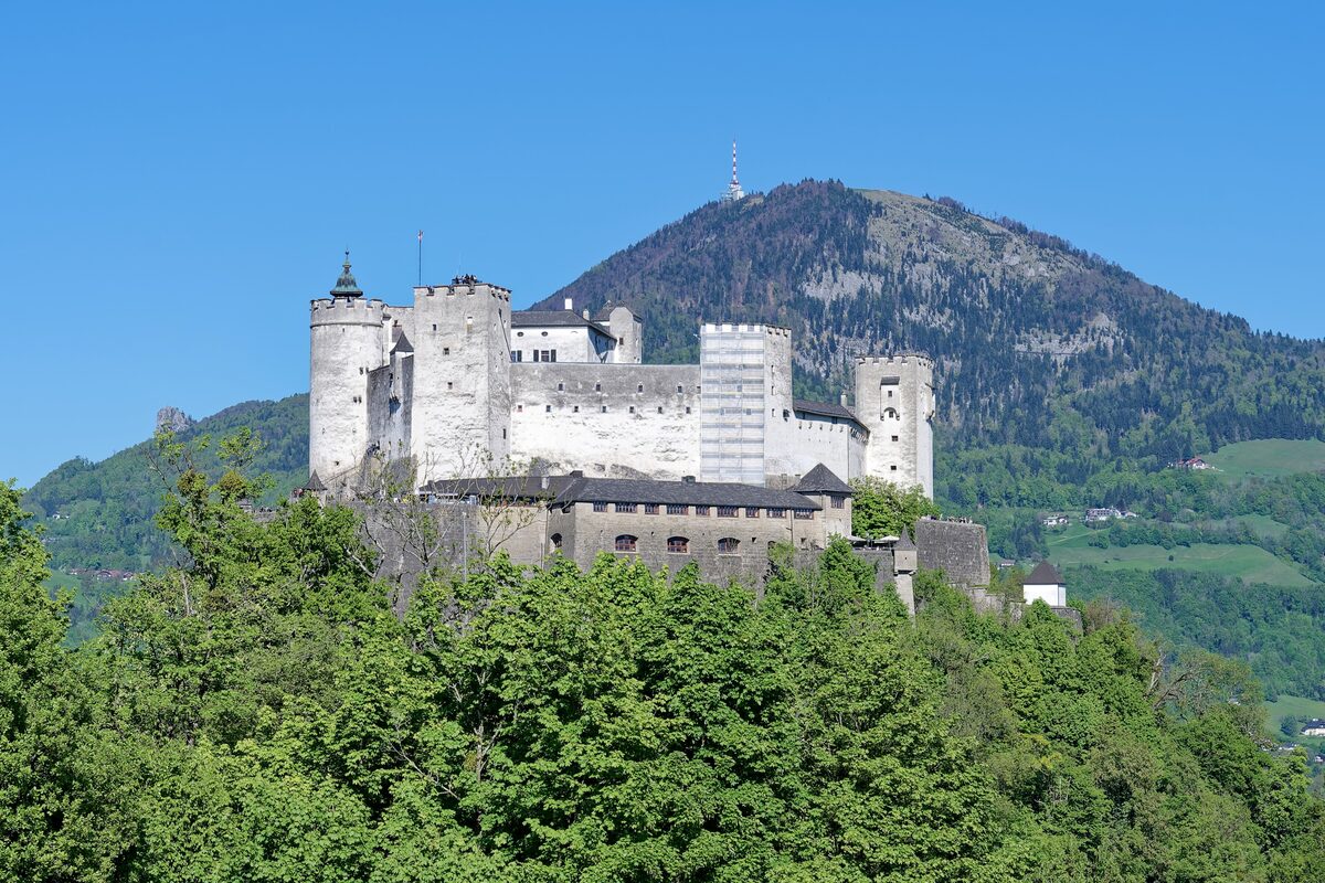 Hohensalzburg Fortress on its wooded hill, with the Gaisberg rising behind it