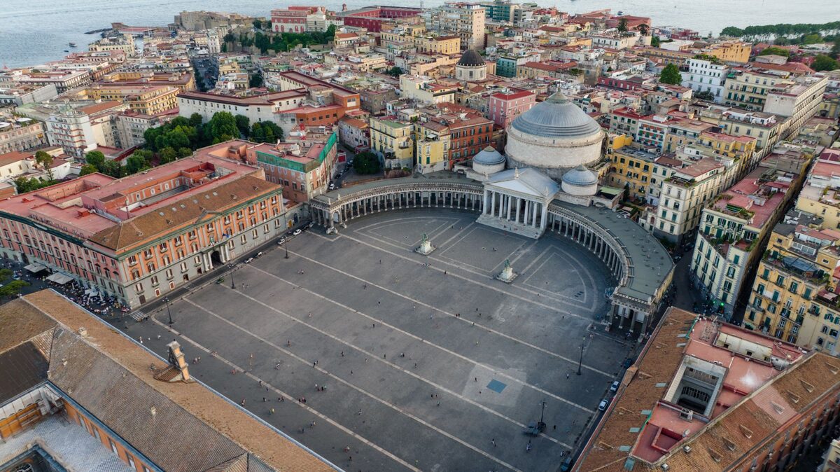 Aerial view of Piazza del Plebiscito in Naples, with the colonnade and dome of San Francesco di Paola on one side and the royal palace on the other