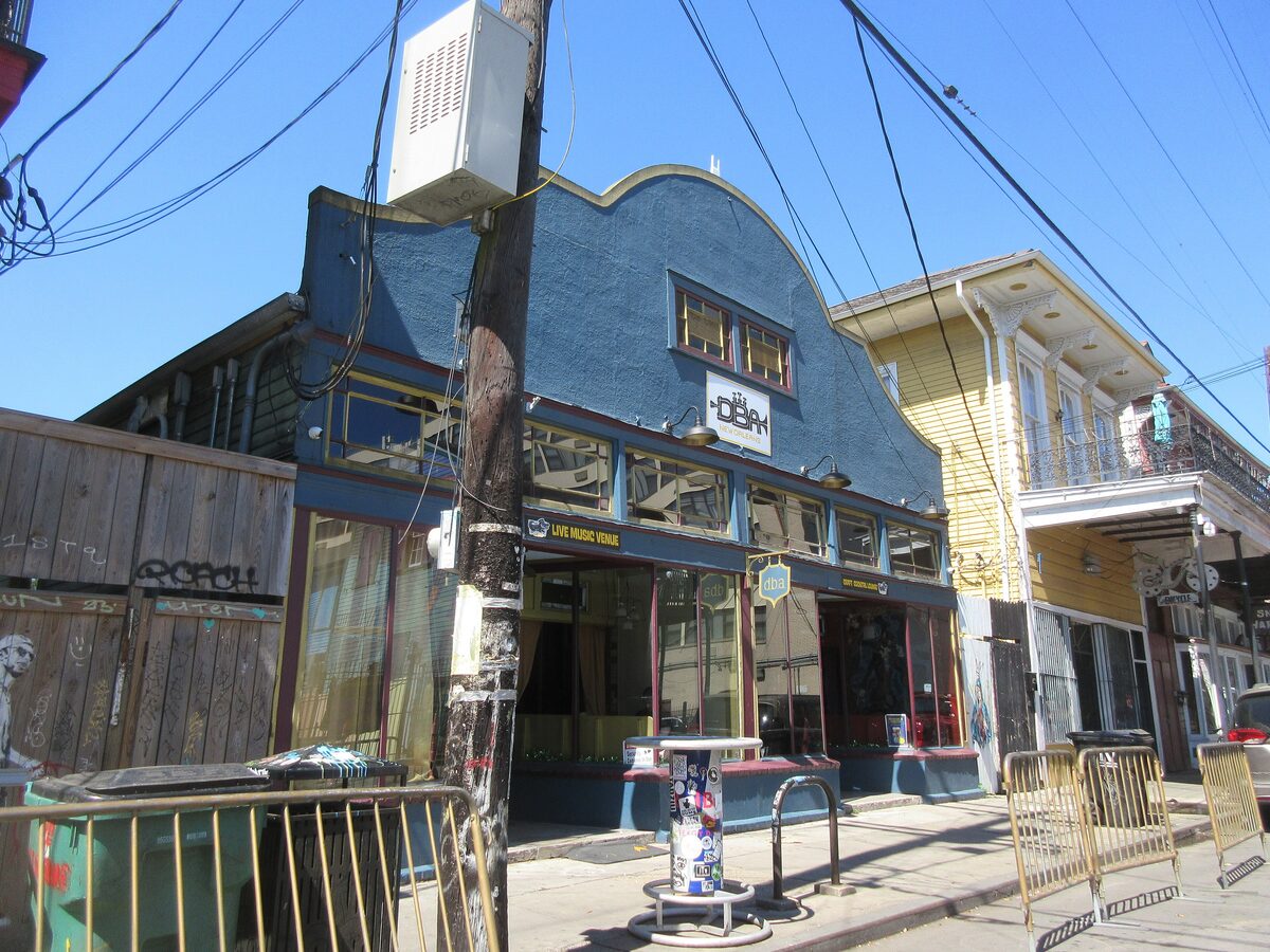 The blue-fronted d.b.a. music club on Frenchmen Street in Faubourg Marigny, with painted shopfronts and a clear sky