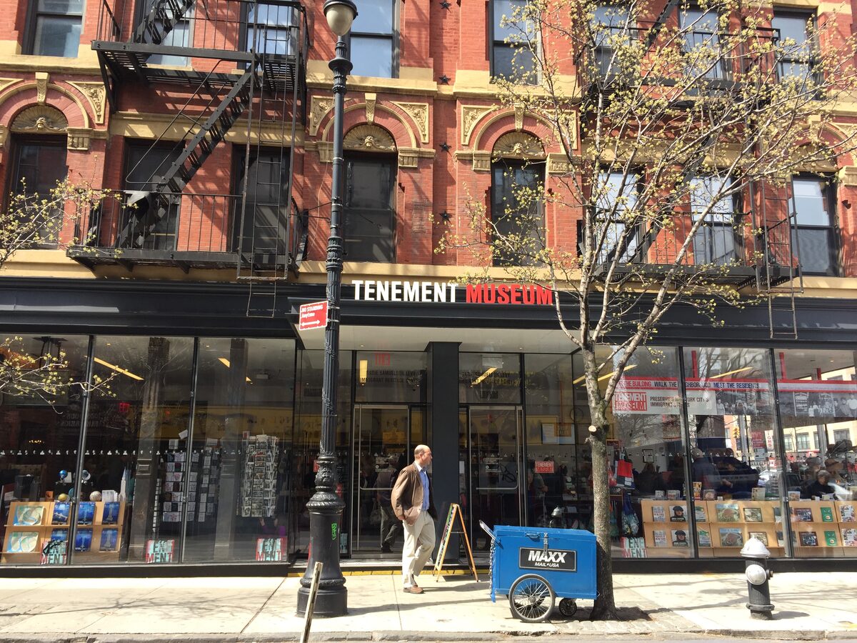 The brick tenement building on Orchard Street with the red Tenement Museum sign above its glass shopfront
