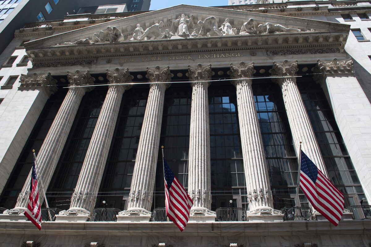 The columned front of the New York Stock Exchange on Broad Street, with its sculpted pediment and American flags