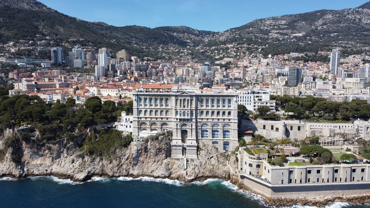 Monaco's rocky headland with the Oceanographic Museum on the cliff edge above the sea and the towers of Monte-Carlo behind