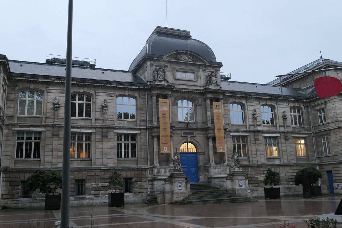 The neoclassical front of the Musée des Beaux-Arts de Rouen, with its blue doors and yellow banners