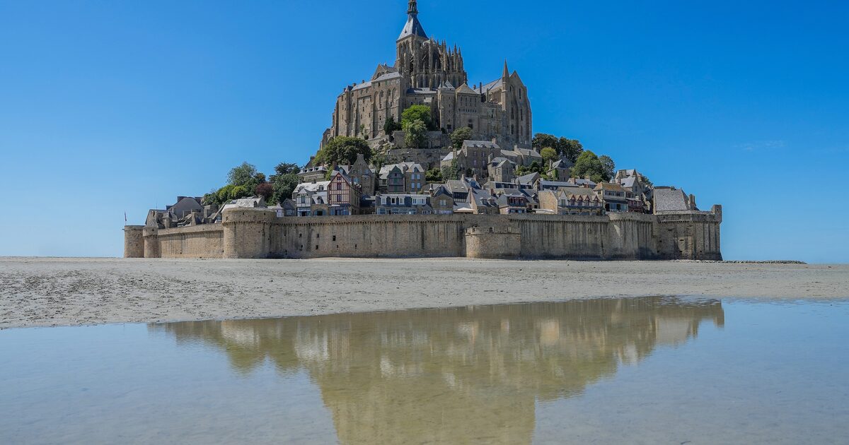 Mont-Saint-Michel and its abbey rising from the tidal flats of the bay