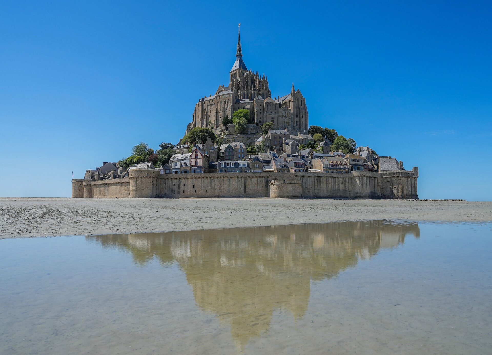 Mont-Saint-Michel and its abbey rising from the tidal flats of the bay