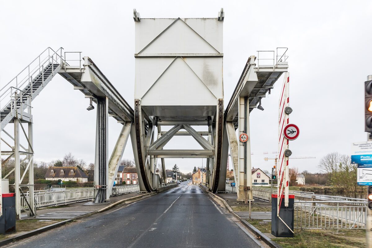 Pegasus Bridge at Bénouville, the white steel lift bridge over the Caen canal with the road running across