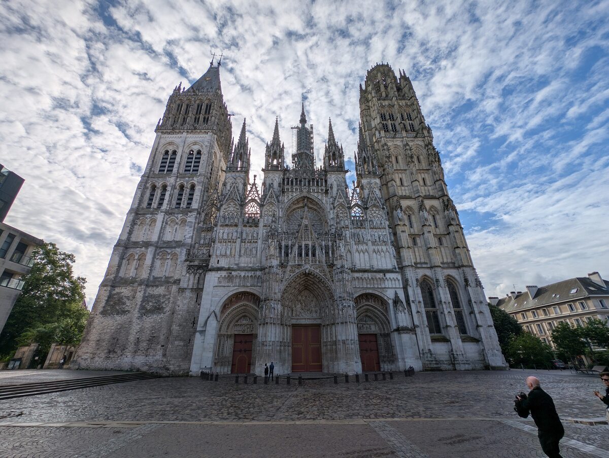 The west front of Rouen Cathedral, its two towers and the central gable with the cobbled square in front