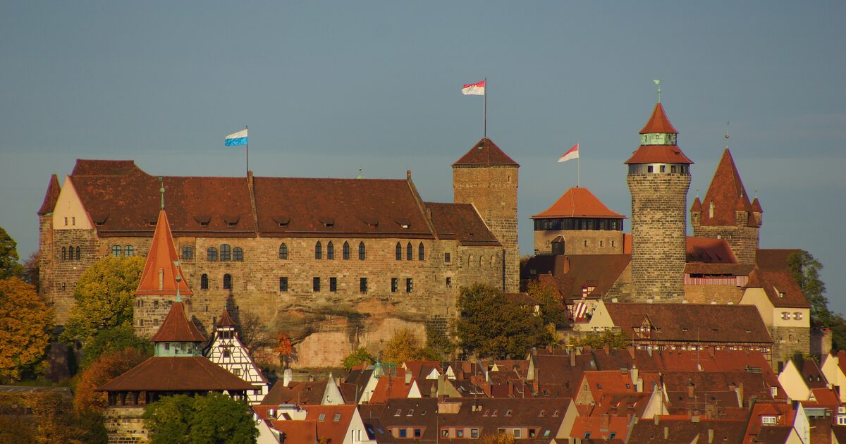 The Imperial Castle above the red roofs of Nuremberg's old town in autumn light, seen from the southwest