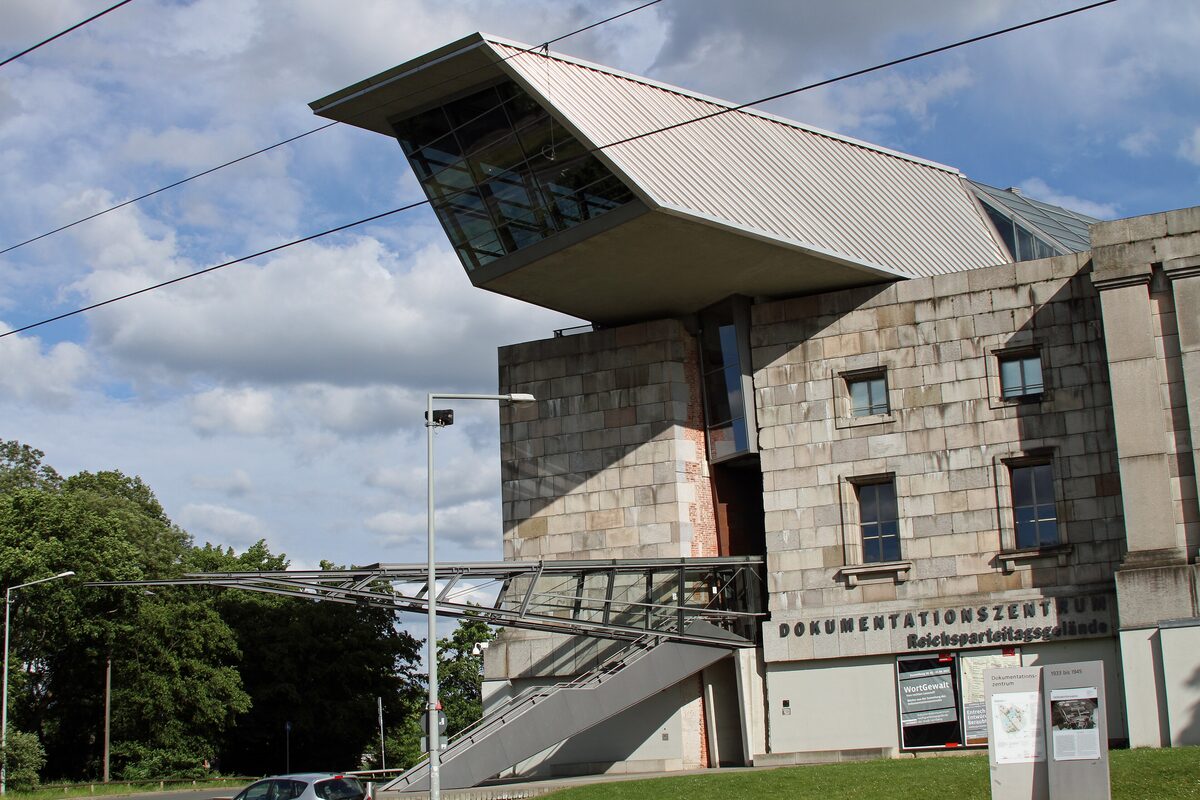 The glass and steel spike of the Documentation Center driven into the unfinished Congress Hall