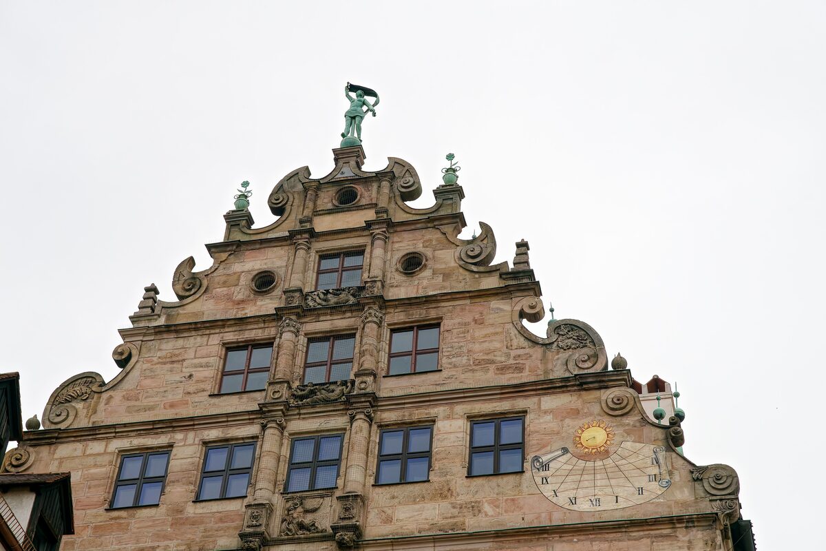 The ornate Renaissance gable of the Fembo-Haus with its sundial and a statue on top