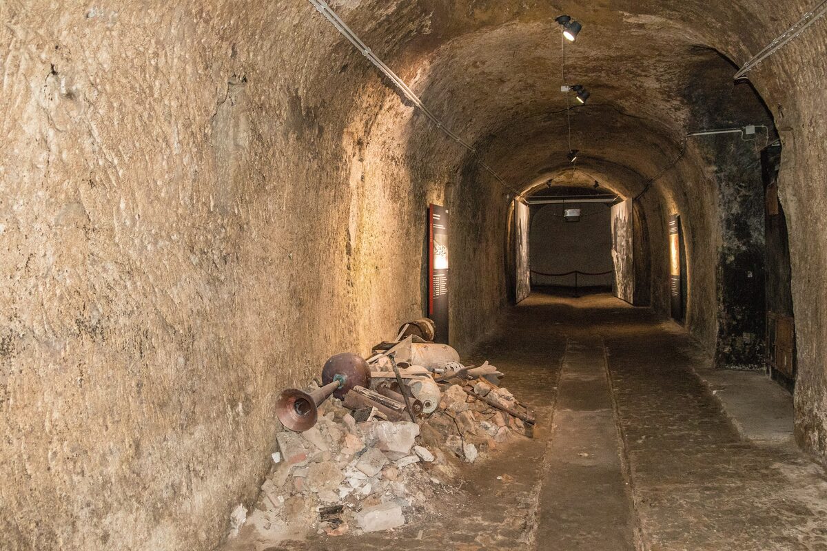 A long arched tunnel with rough walls and a dusty floor in the Historic Art Bunker