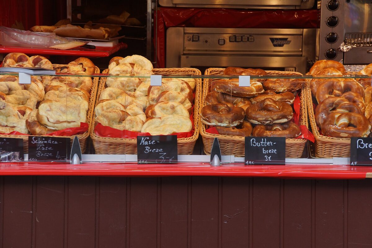 Baskets of fresh Brezen and pretzel rolls at a bakery stall