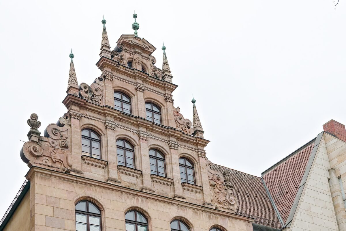 The stepped Renaissance gable and pinnacles of the building at Karlstraße 13 that houses the Toy Museum