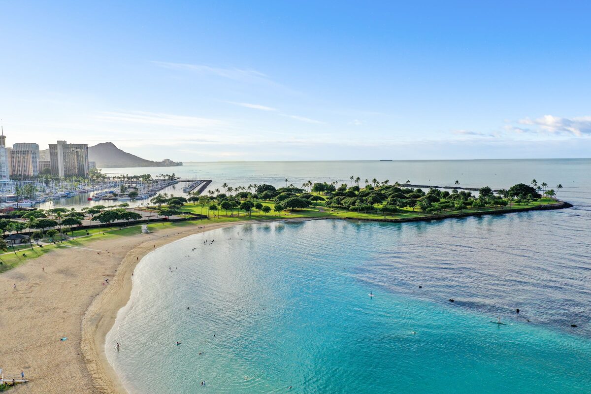 Ala Moana Beach Park's curved sand and Magic Island with Diamond Head beyond