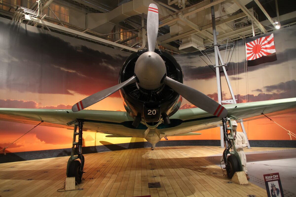A Japanese Zero fighter displayed head-on in the aviation museum hangar
