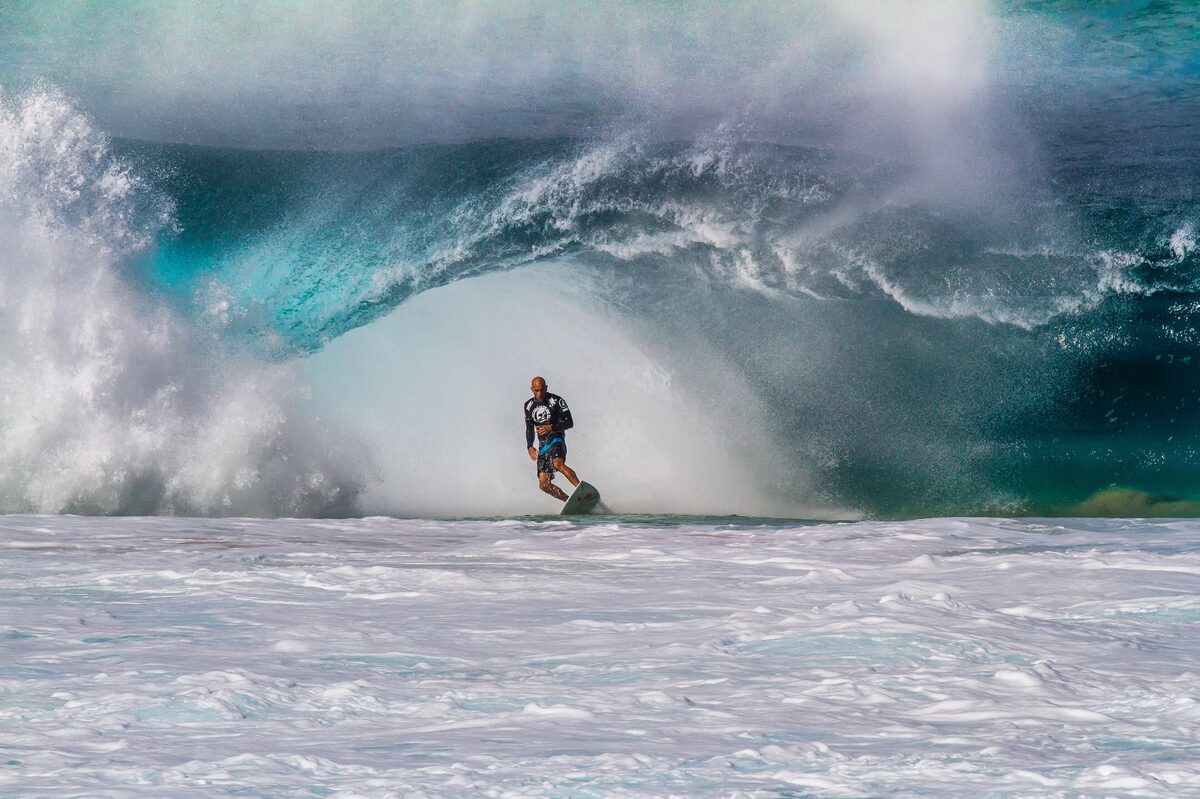 A surfer tucked inside a hollow Banzai Pipeline wave