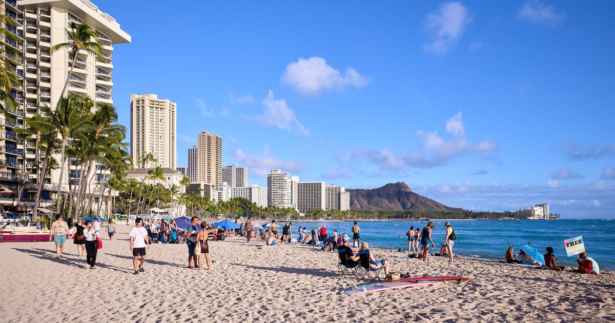 Waikiki Beach with Diamond Head rising behind the Honolulu skyline