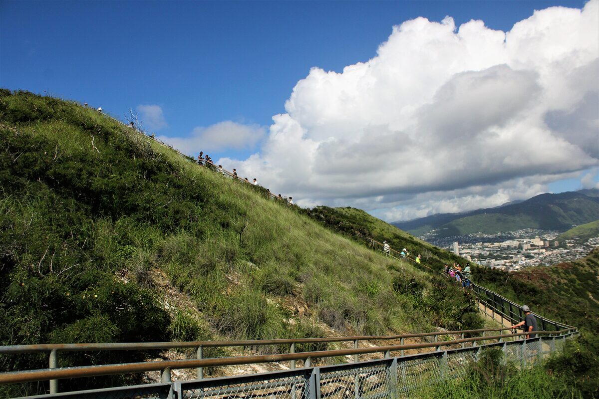 The Diamond Head trail climbing a green crater slope above Honolulu