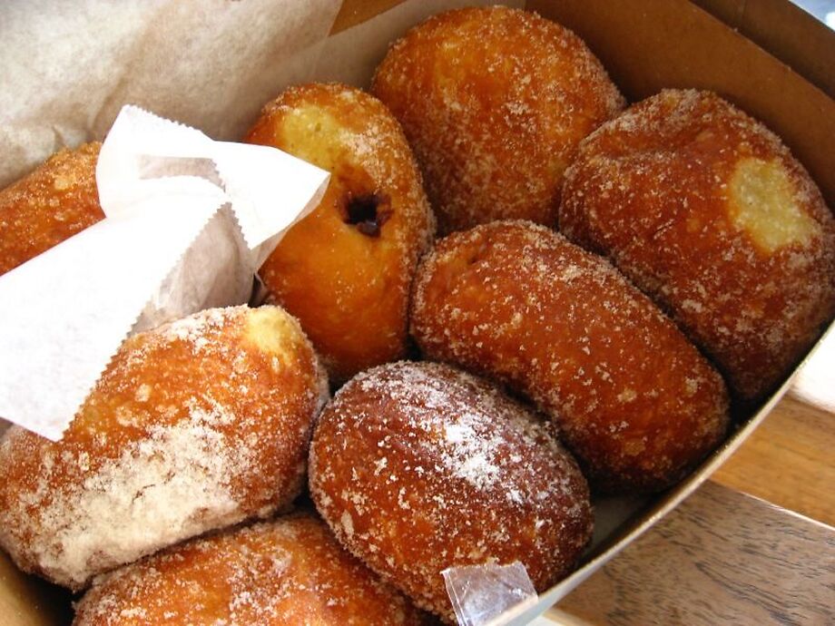 A box of sugar-coated Leonard's malasadas, some filled with custard