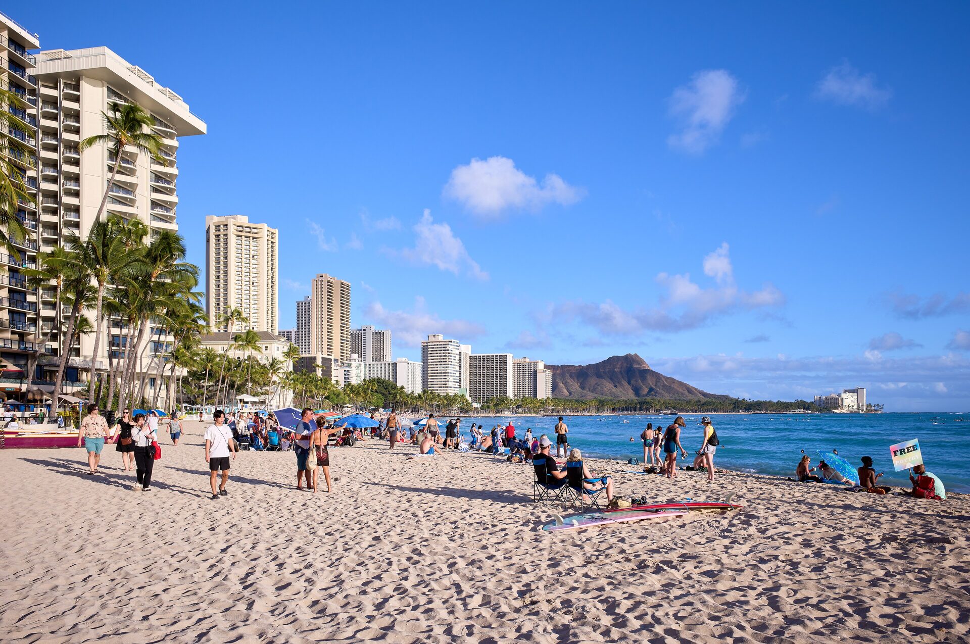 Waikiki Beach with Diamond Head rising behind the Honolulu skyline