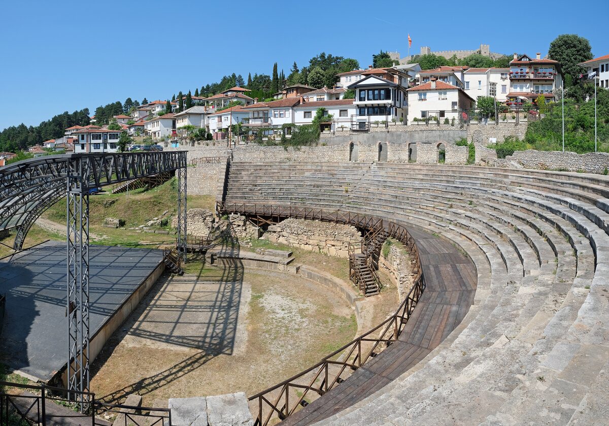 The stone tiers of the Ancient Theatre in Ohrid with the Varoš houses above