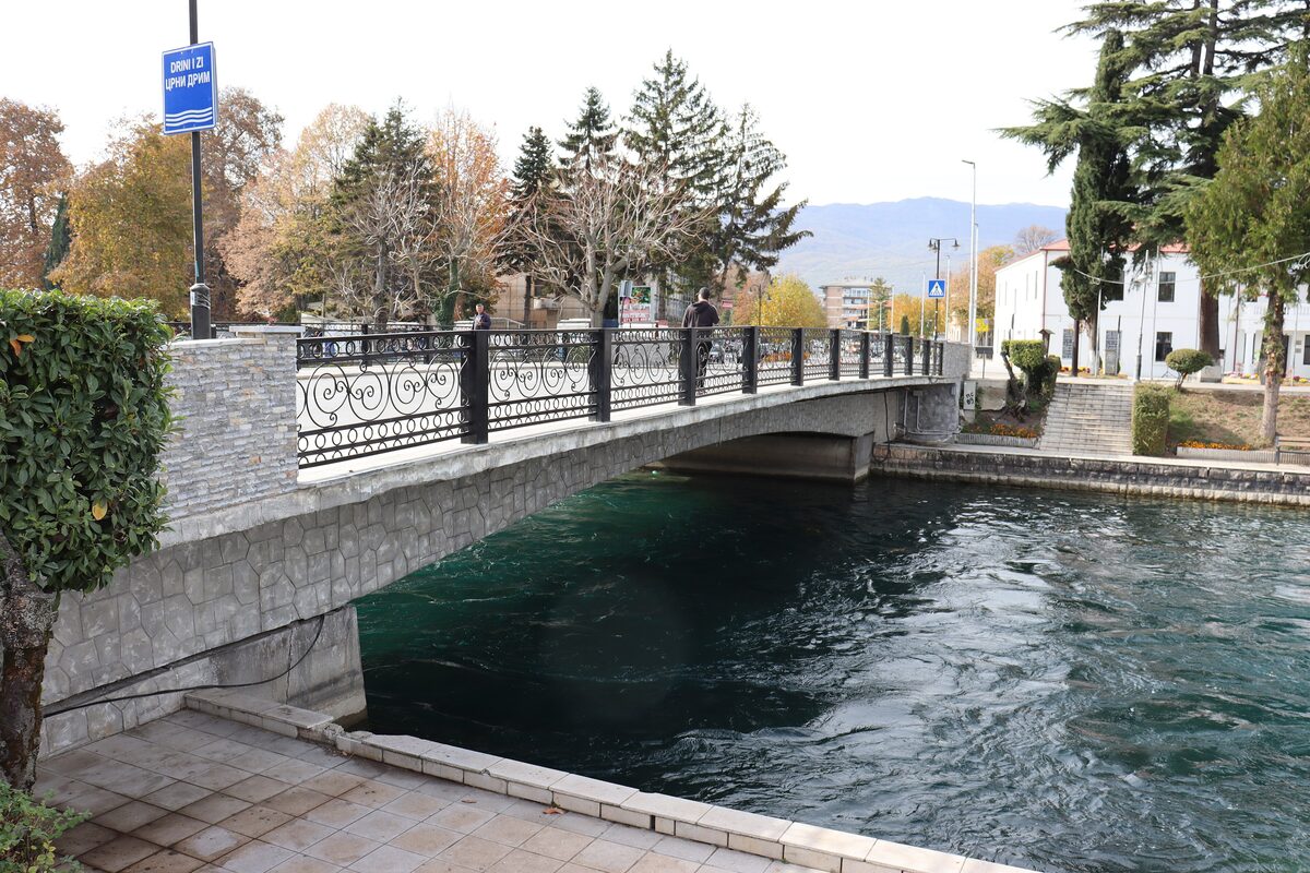 The Bridge of Poetry over the Black Drim river in Struga, with dark green water below
