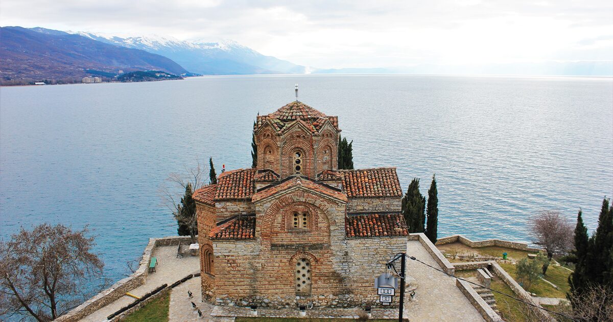The Church of St. John at Kaneo on its cliff above the blue water of Lake Ohrid