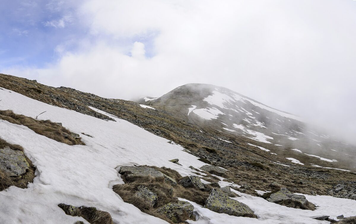 Snow patches and cloud on the rocky slopes of Mount Pelister