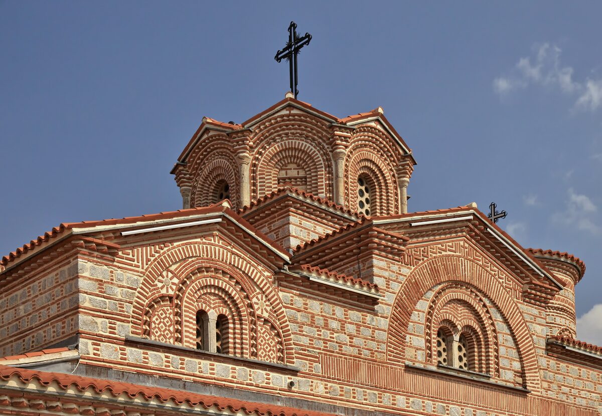 Brick walls, arched windows and a dome on the Church of St. Clement and Pantaleon at Plaošnik