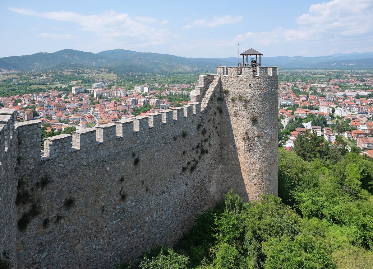 The round tower and walls of Samuel's Fortress above the red roofs of Ohrid