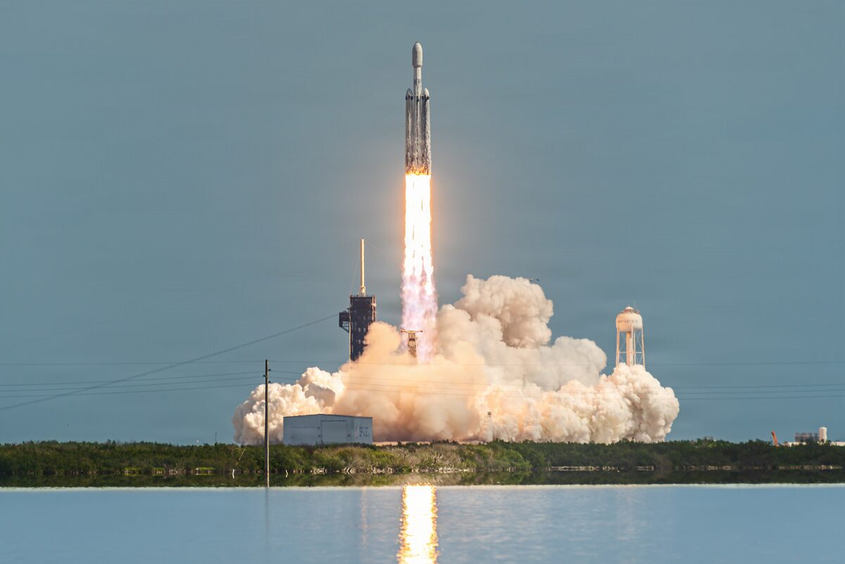 Falcon Heavy lifting off from Kennedy Space Center across the water