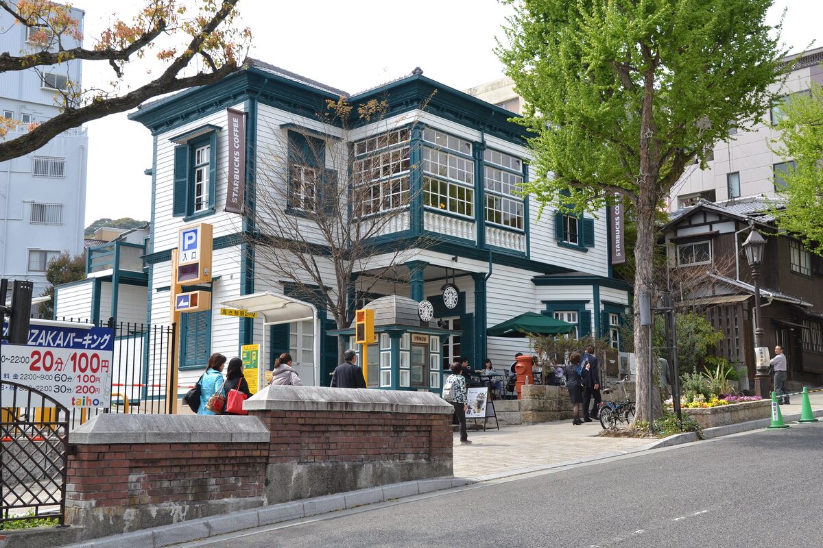 Old Freundlieb's Residence, a white Western-style house with green trim on a tree-lined street in Kitano