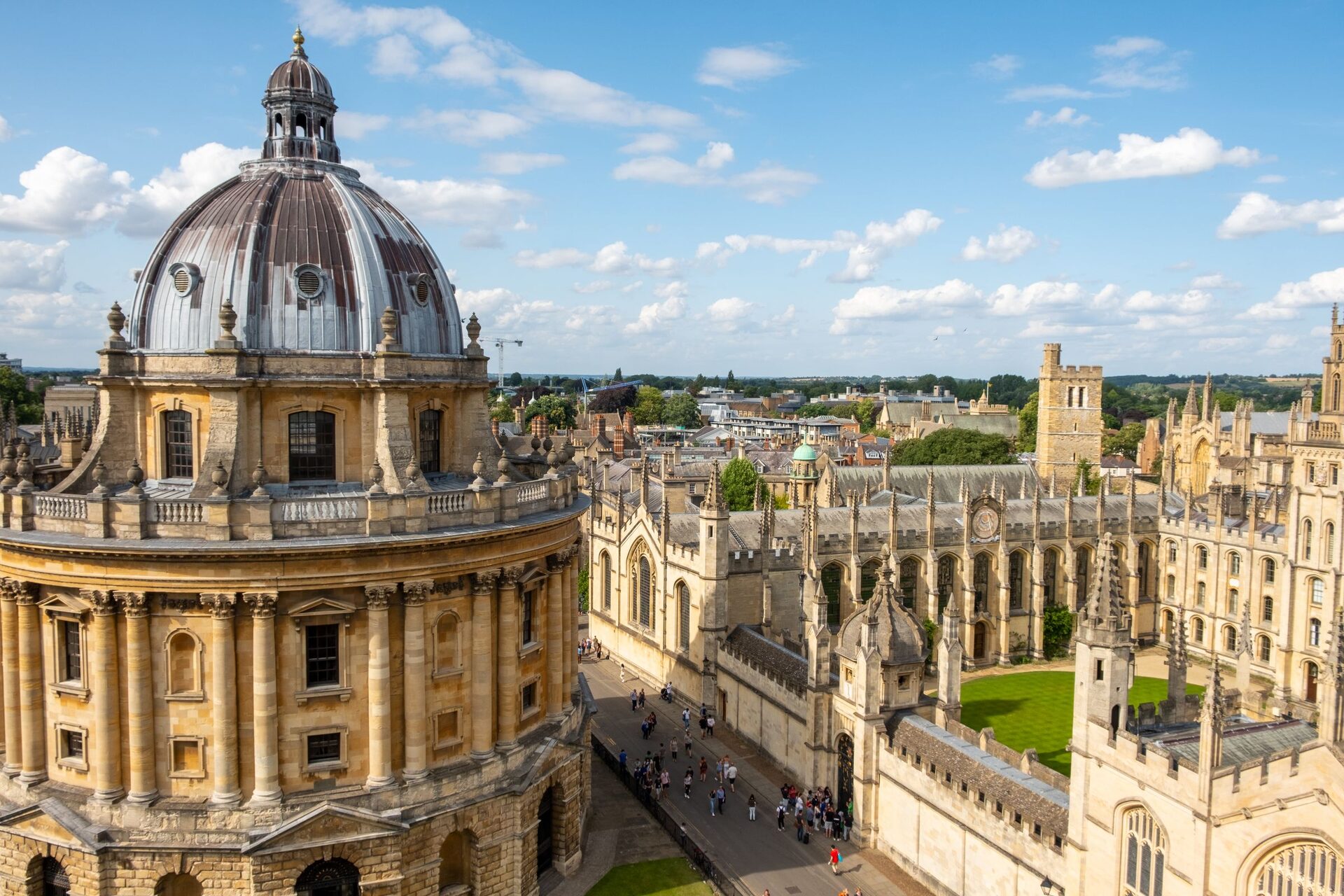 Aerial view of the Radcliffe Camera's dome in Oxford, with the spires and quadrangles of All Souls College and the old city around it