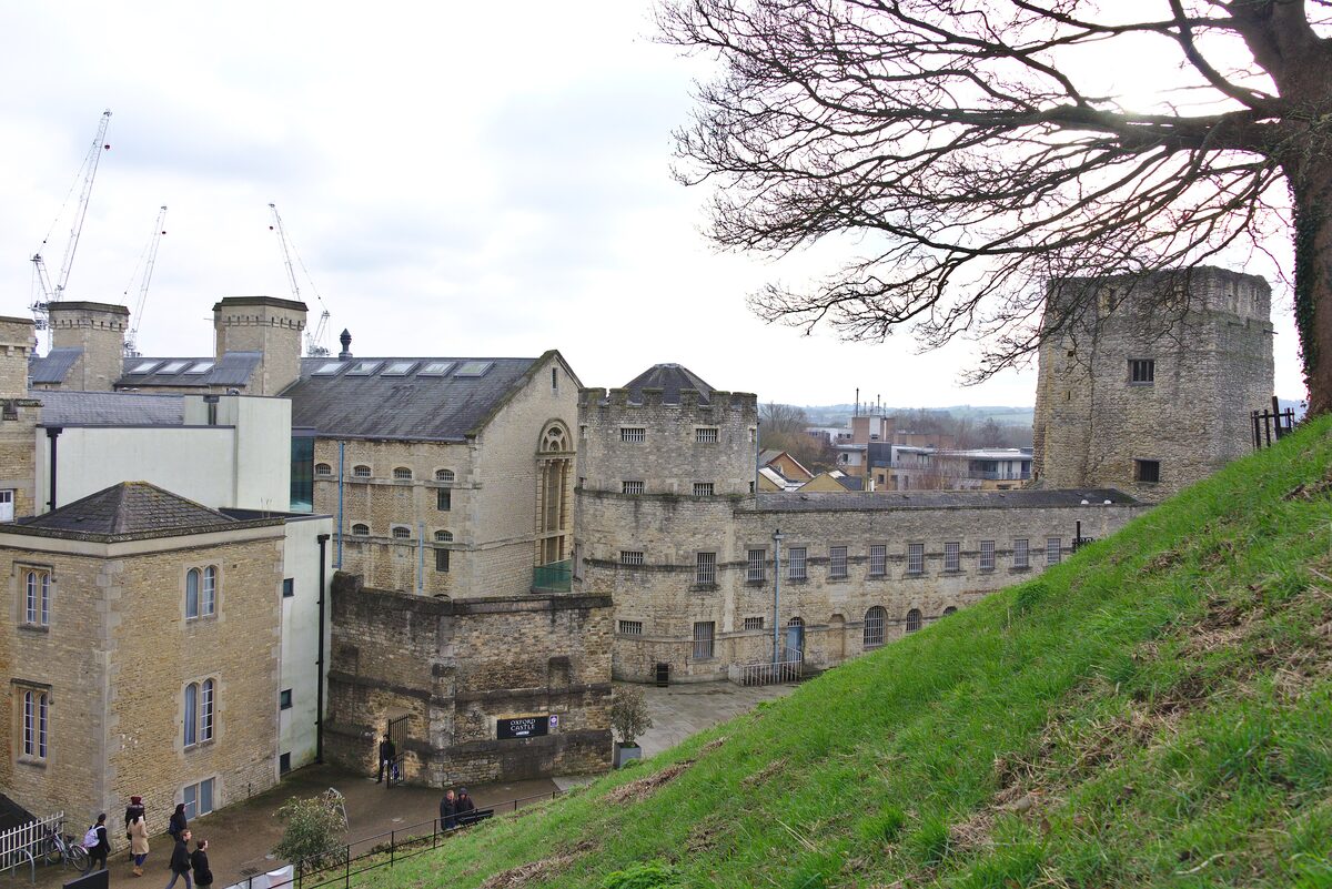 Oxford Castle's tall square St George's Tower and the old prison buildings below the grassy castle mound