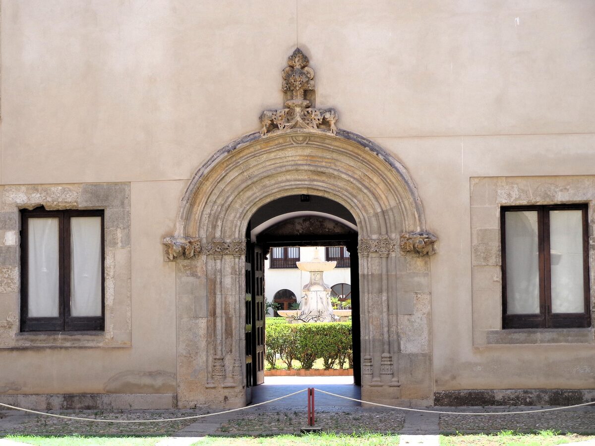 The carved stone entrance of Palazzo Abatellis, with the courtyard garden beyond