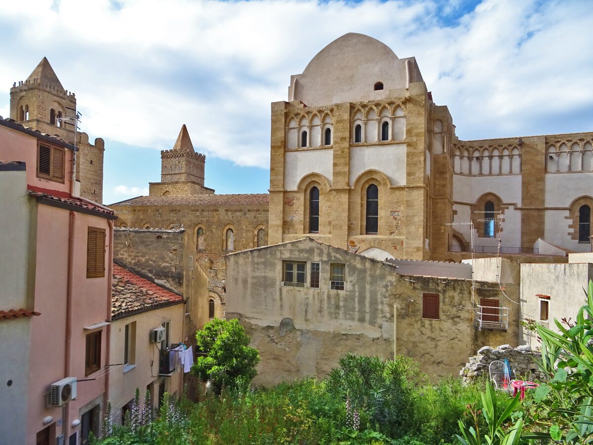 The apse and towers of Cefalù Cathedral above the old town roofs