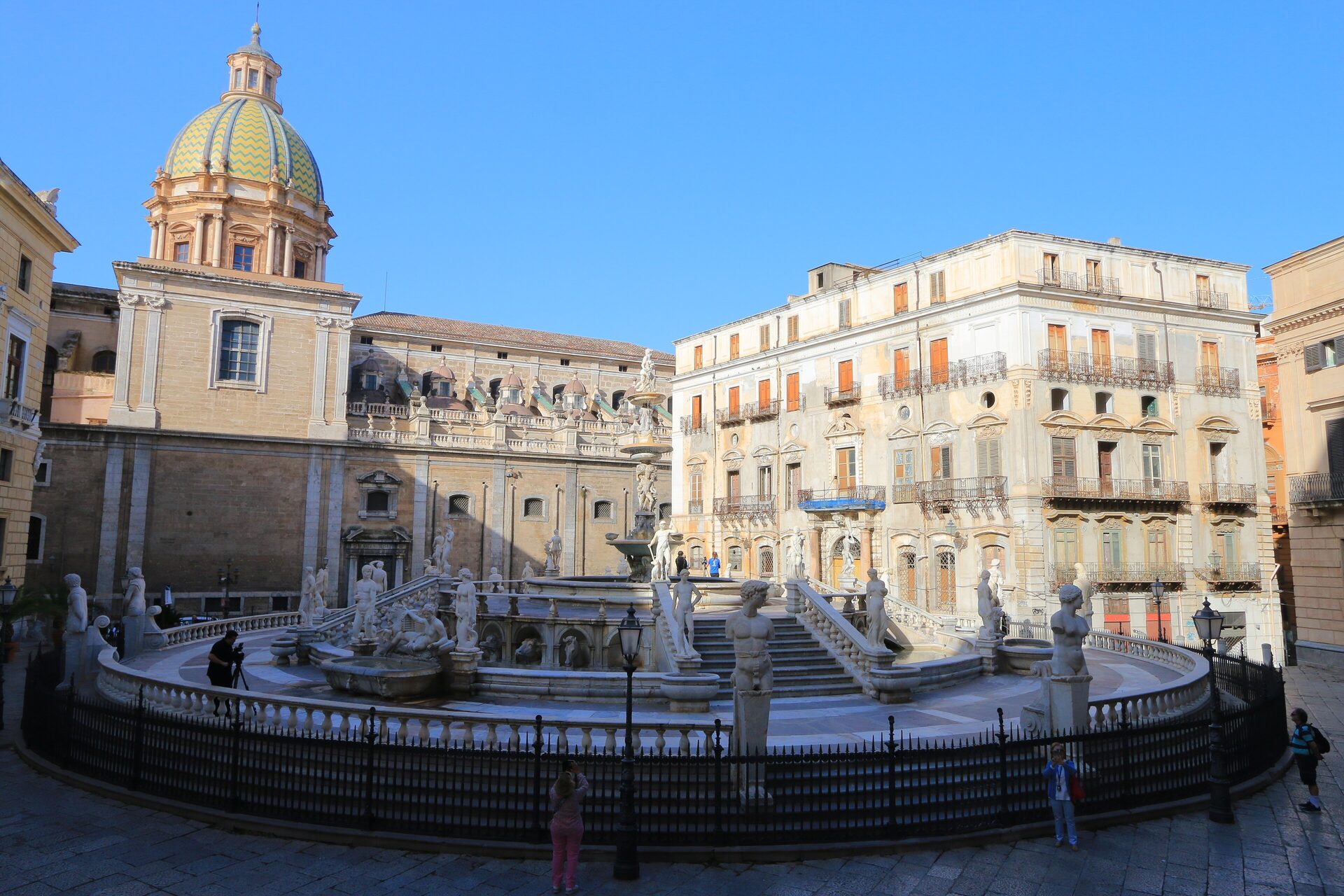 The Pretoria fountain and the tiled dome of San Giuseppe dei Teatini under a blue sky