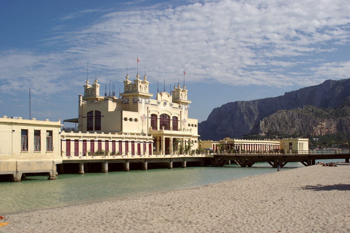 The Art Nouveau Charleston bathing pavilion on its pier, with Mondello's sandy beach