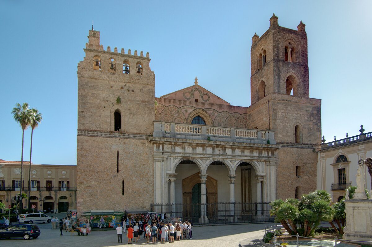 The front of Monreale Cathedral, with two towers and a three-arched porch