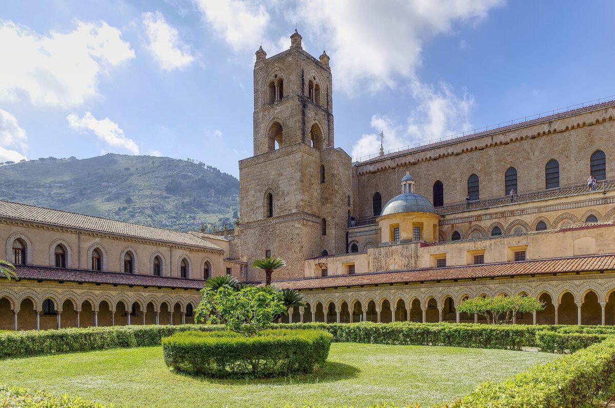 The arcaded Monreale cloister and the cathedral tower above a clipped garden