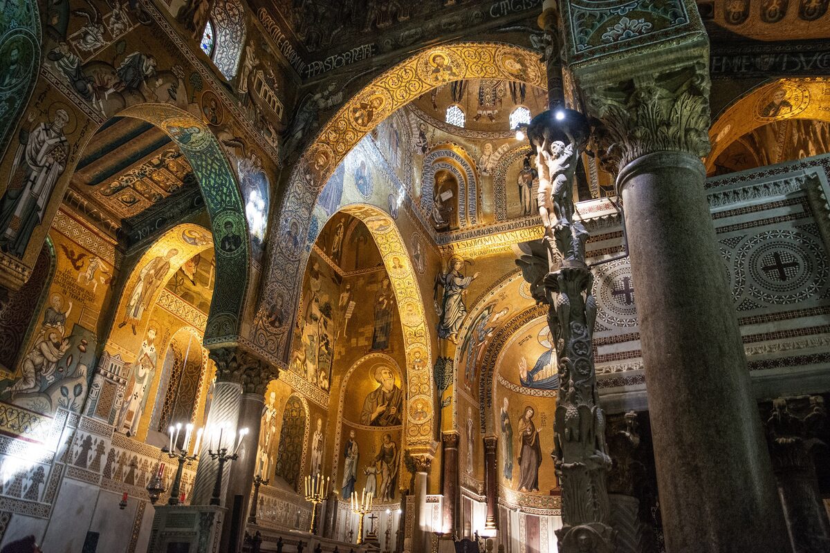 The gold mosaics and carved columns inside the Cappella Palatina