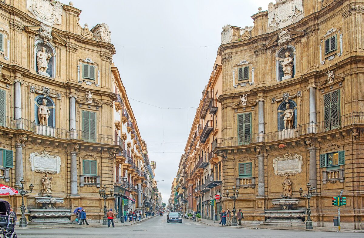 The curved baroque facades of the Quattro Canti crossroads, seen down the street