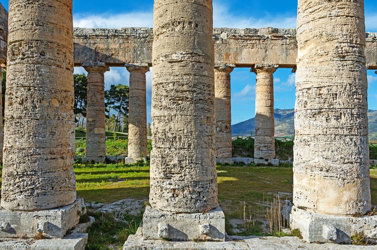 Doric columns of the unfinished temple at Segesta framing the hills