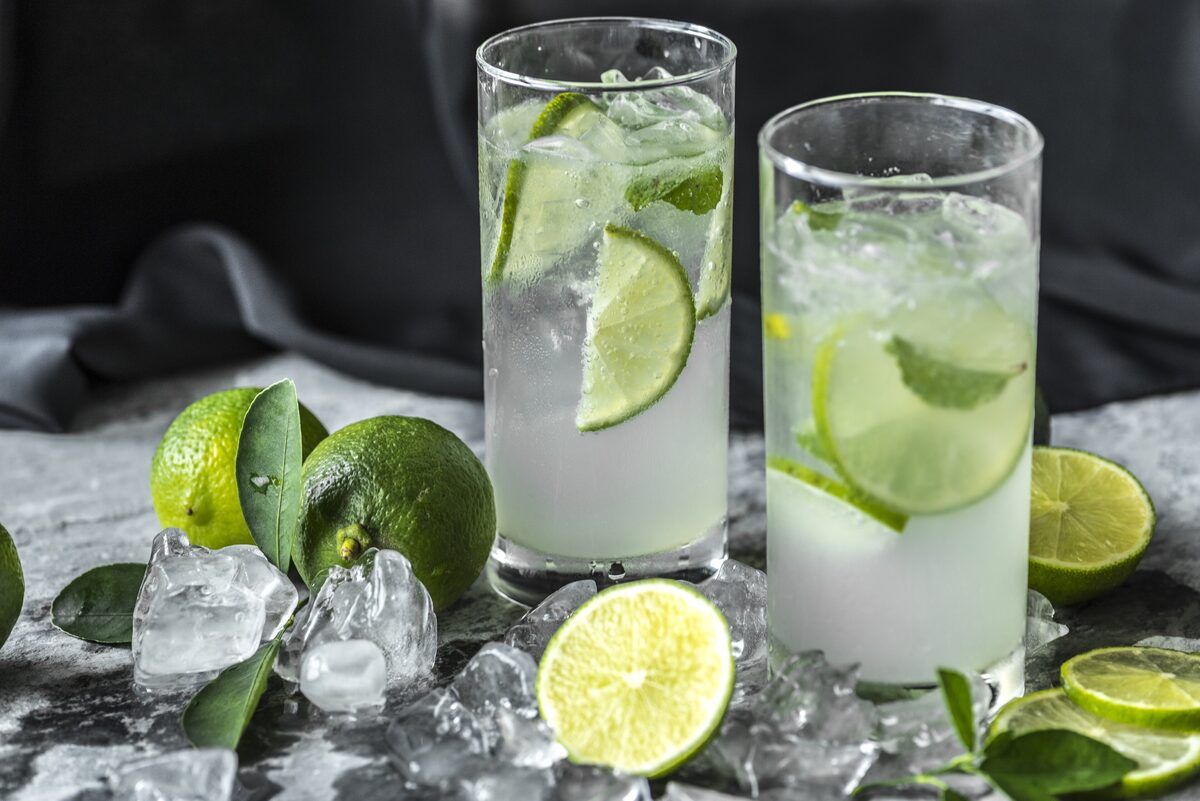 Two glasses of caipirinha with crushed ice and fresh lime