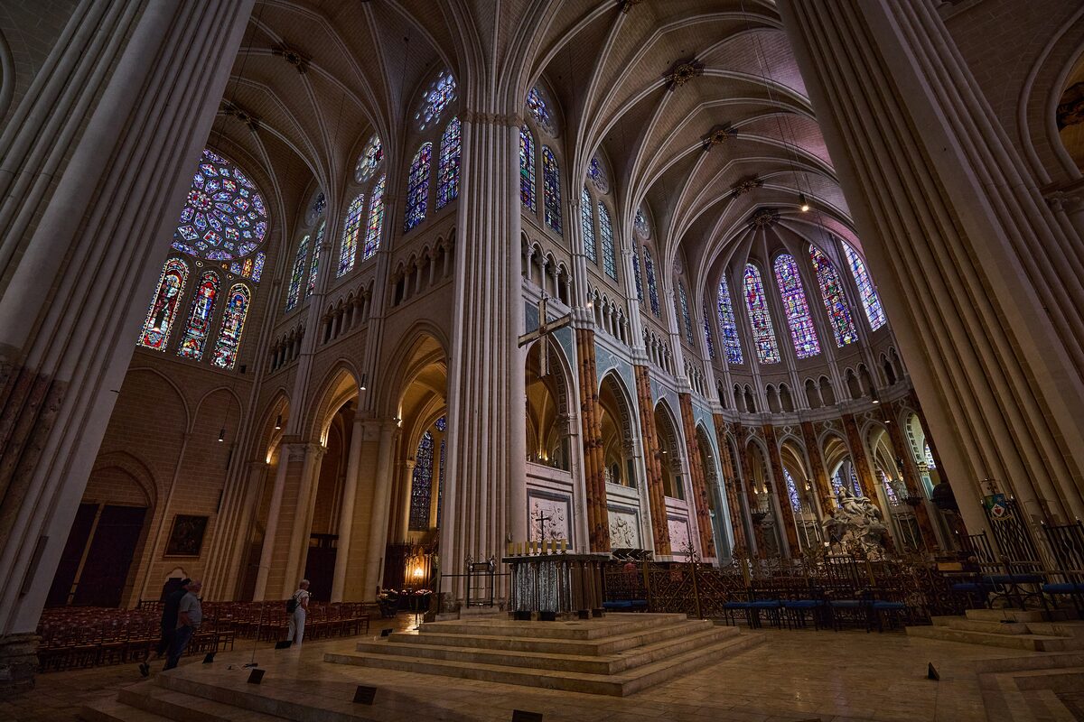The nave of Chartres Cathedral, with tall stone piers and stained-glass windows