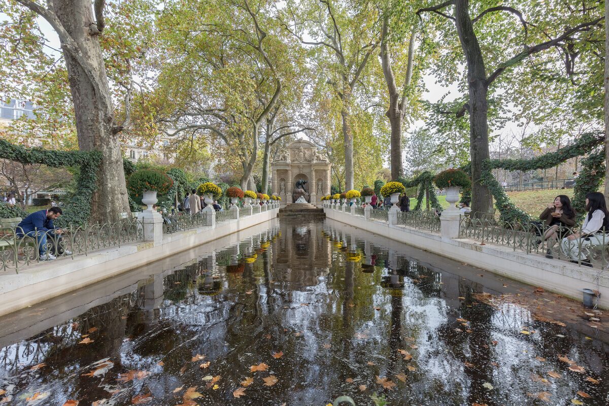 The long basin of the Medici Fountain in the Luxembourg Gardens, with trees reflected in the water